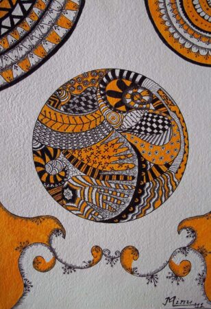 Colorful circular tribal art with black, orange, and white patterns.