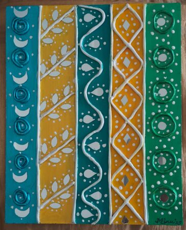 Colorful decorative wall with intricate patterns in blue, yellow, green, and white.